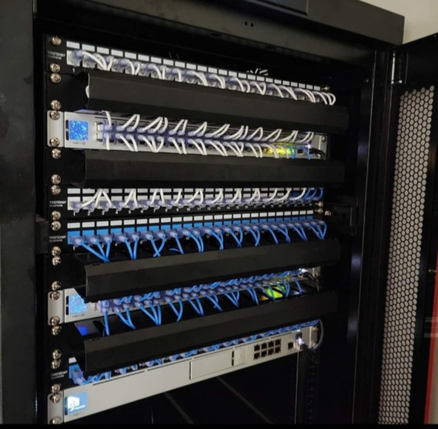 Documented network rack installation with organized patch cabling and installed infrastructure